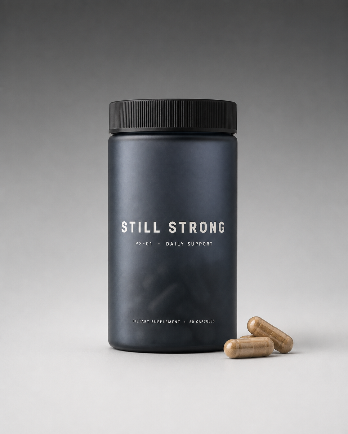 Still Strong bottle beside two capsules